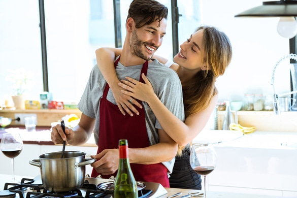 happy young couple cooking together in the kitchen at home - Signs An Aquarius May Be In Love With You